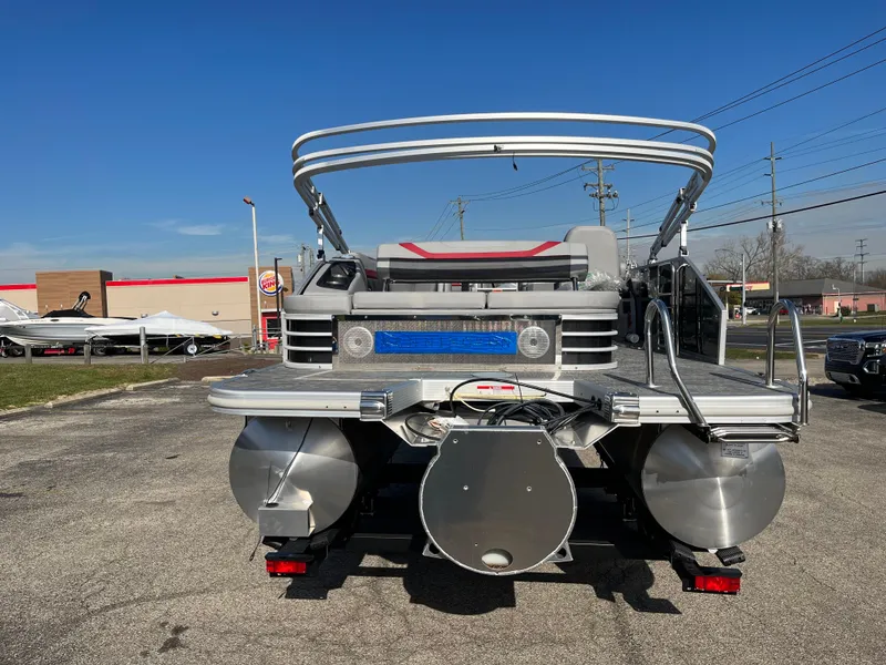 Slide: The Image of 2023 Bennington SX Line pontoon boat rear view in a parking lot. - 12