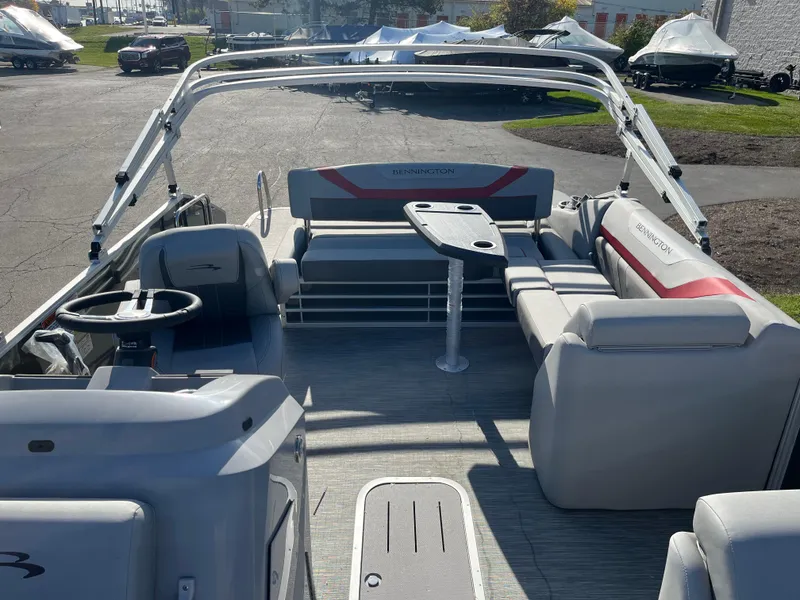 Slide: The Image of 2023 Bennington SX Line pontoon boat interior with seating and table. - 3