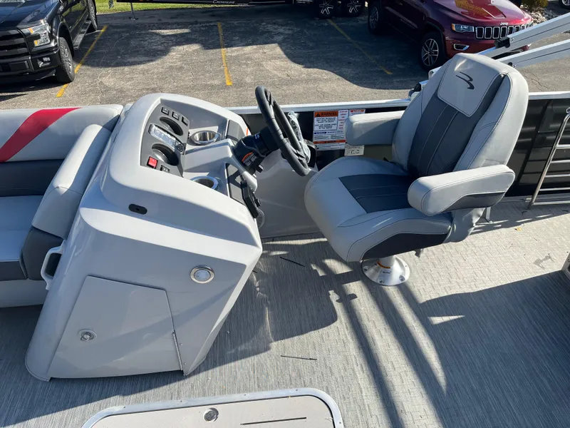 Slide: The Image of 2023 Bennington SX Line boat helm with captain's chair and control panel. - 5