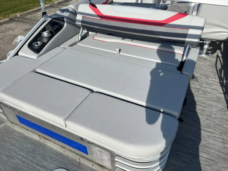 Slide: The Image of 2023 Bennington SX Line boat with gray and red cushioned seating. - 8