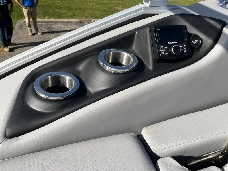 Slide: The Image of 2023 Bennington SX Line boat console with cup holders and audio controls. - 9
