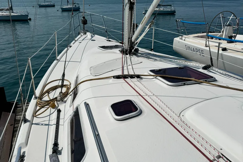 Slide: The Image of 2005 Hunter 38 sailboat deck with ropes and hatches, docked in a marina. - 10