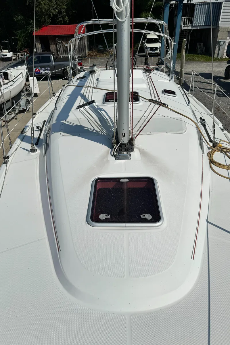 Slide: The Image of 2005 Hunter 38 sailboat deck with mast and hatch, docked in marina. - 11