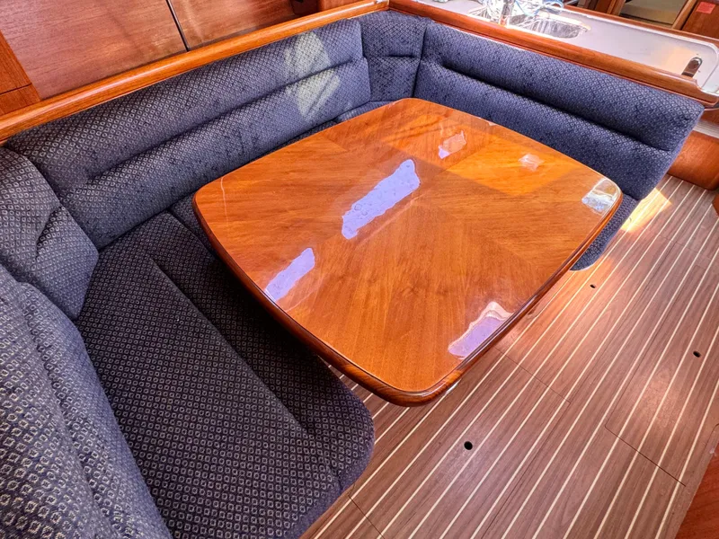 Slide: The Image of Luxurious 2005 Hunter 38 yacht interior with elegant wood table and plush seating. - 17