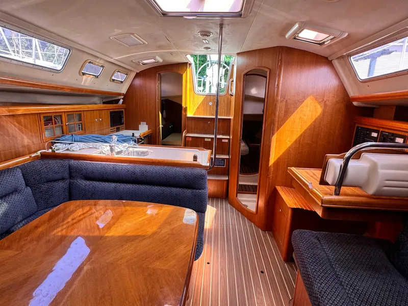 Slide: The Image of Interior of 2005 Hunter 38 sailboat with wood finish and seating area. - 18