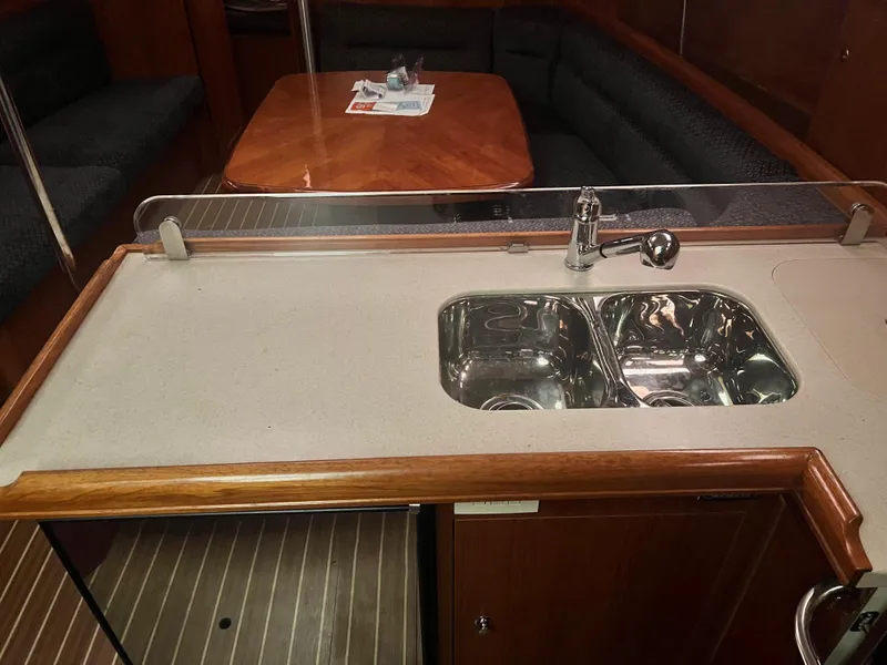 Slide: The Image of Hunter 38 2005 yacht interior with kitchen sink and dining area. - 22