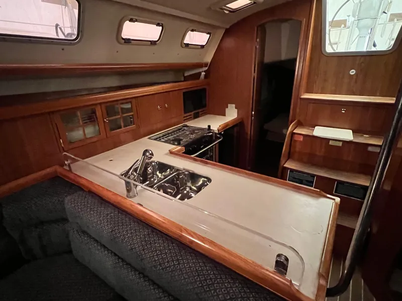 Slide: The Image of Interior of 2005 Hunter 38 sailboat with kitchen and seating area. - 24