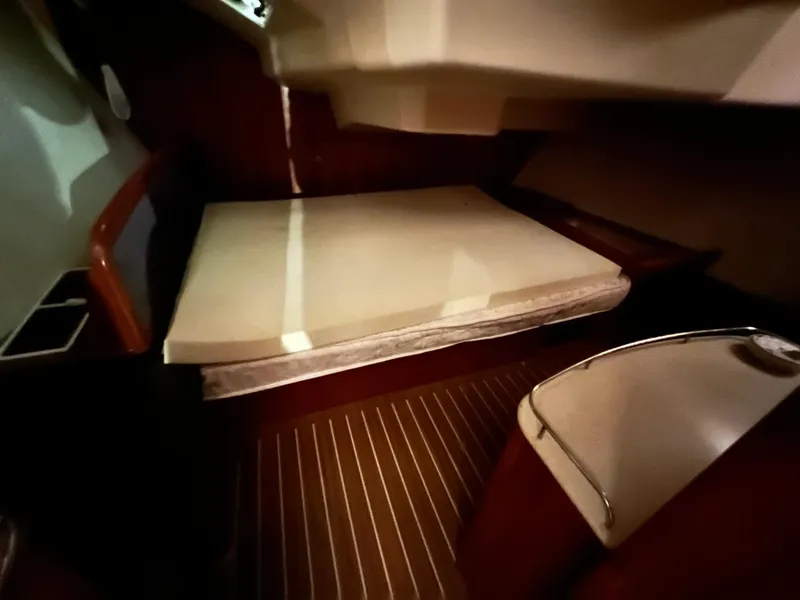 Slide: The Image of Interior cabin of a 2005 Hunter 38 sailboat with a bed and wooden flooring. - 28