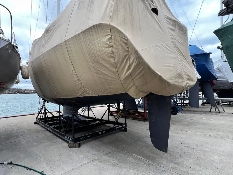 Slide: The Image of Covered 2005 Hunter 38 sailboat on a stand at a marina. - 35