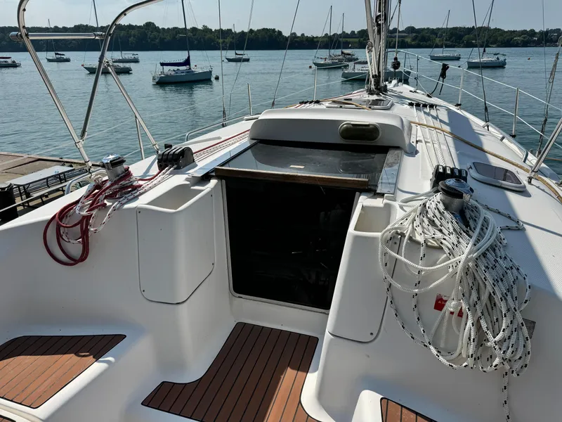 Slide: The Image of Hunter 38 sailboat deck, 2005 model, with ropes and equipment, docked in a marina. - 7