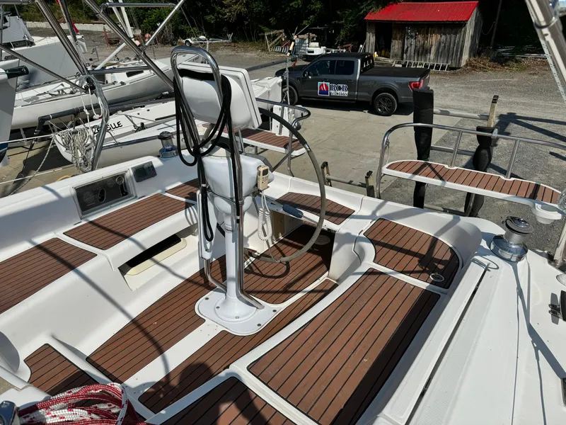Slide: The Image of 2005 Hunter 38 sailboat cockpit with wooden deck and steering wheel. - 8