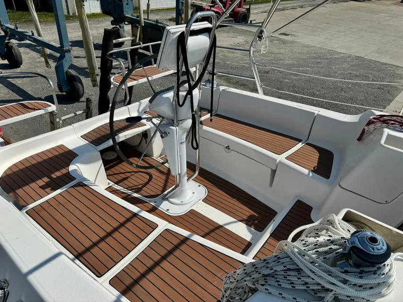 Slide: The Image of 2005 Hunter 38 sailboat cockpit with teak flooring and steering wheel. - 9