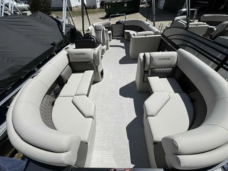 Slide: The Image of 2024 Harris Sunliner 210 pontoon boat with spacious seating and modern design. - 7