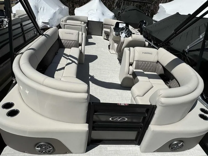 Slide: The Image of 2024 Harris Sunliner 210 pontoon boat with spacious seating and modern design. - 8