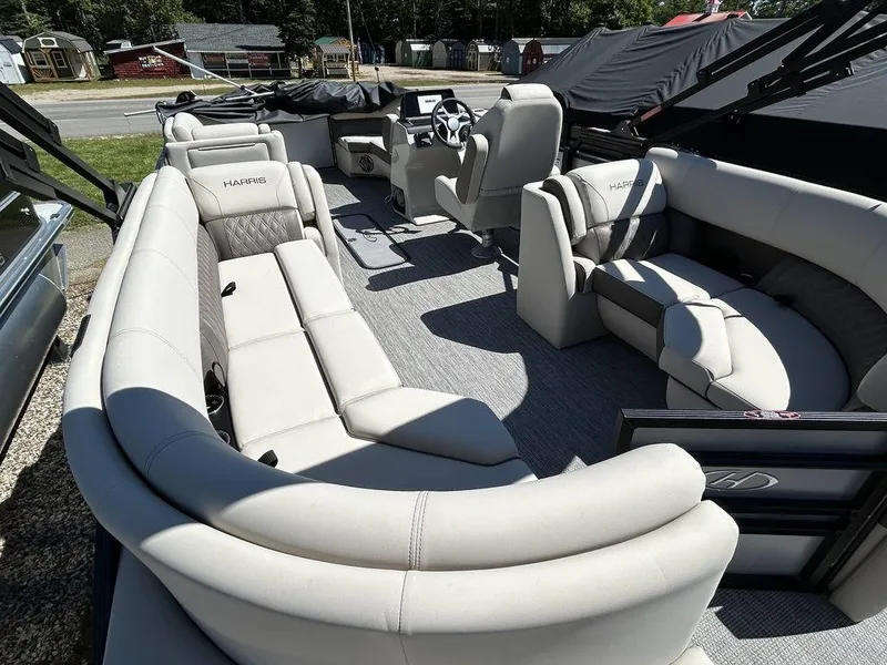 Slide: The Image of 2024 Harris Sunliner 210 pontoon boat interior with plush seating and modern design. - 10