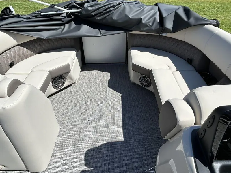 Slide: The Image of 2024 Harris Sunliner 210 boat interior with plush seating and carpeted flooring. - 15