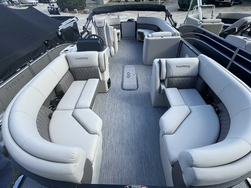 Slide: The Image of 2024 Harris Sunliner 210 pontoon boat with spacious seating and modern design. - 4
