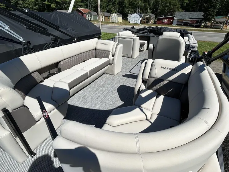Slide: The Image of 2024 Harris Sunliner 210 pontoon boat with spacious seating and modern design. - 9