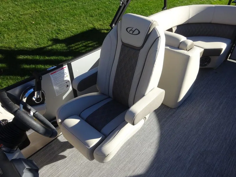 Slide: The Image of 2024 Harris Sunliner 210 boat interior with plush seating and modern design. - 12