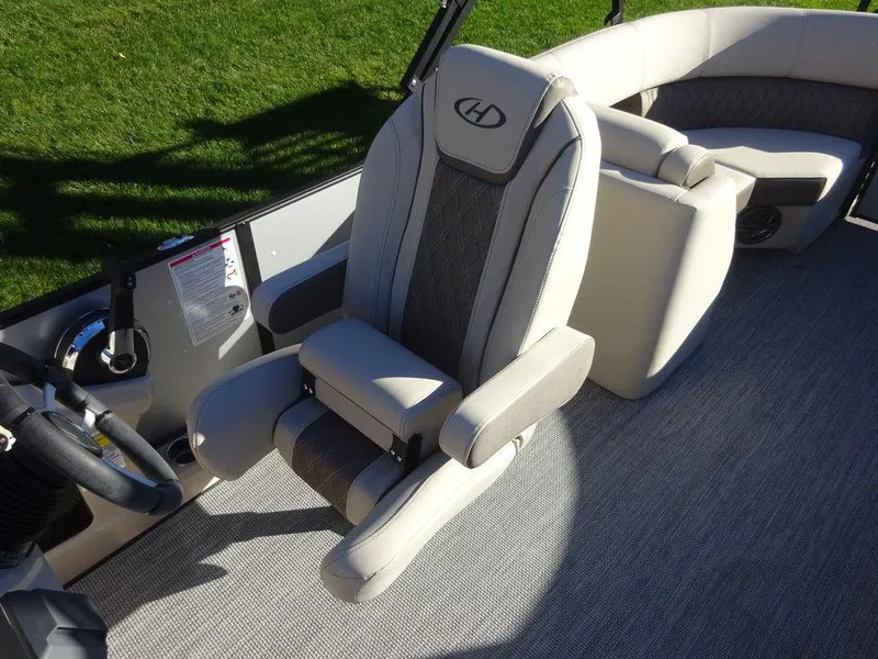 Slide: The Image of 2024 Harris Sunliner 210 boat interior with plush seating and modern design. - 13