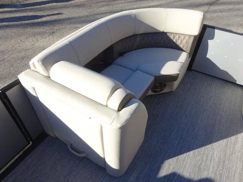 Slide: The Image of 2024 Harris Sunliner 210 boat interior with plush seating and modern design. - 18