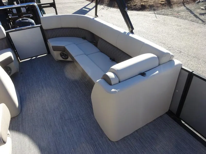 Slide: The Image of 2024 Harris Sunliner 210 boat interior with beige seating and carpeted flooring. - 9