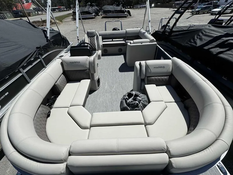 Slide: The Image of 2024 Harris Sunliner 210 pontoon boat with spacious seating and modern design. - 5