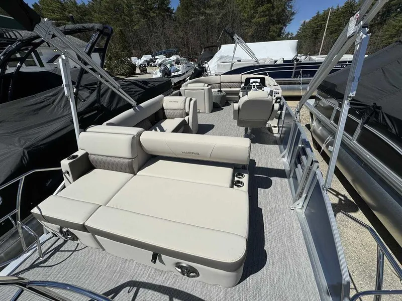 Slide: The Image of 2024 Harris Sunliner 210 pontoon boat with spacious seating and modern design. - 7