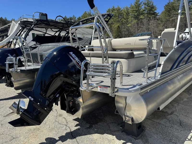 Slide: The Image of 2024 Harris Sunliner 210 pontoon boat with Mercury outboard motor, docked outdoors. - 8