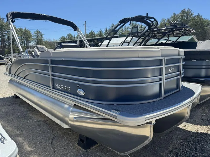 Slide: The Image of 2024 Harris Sunliner 210 pontoon boat in a showroom, featuring sleek design and modern amenities. - 9