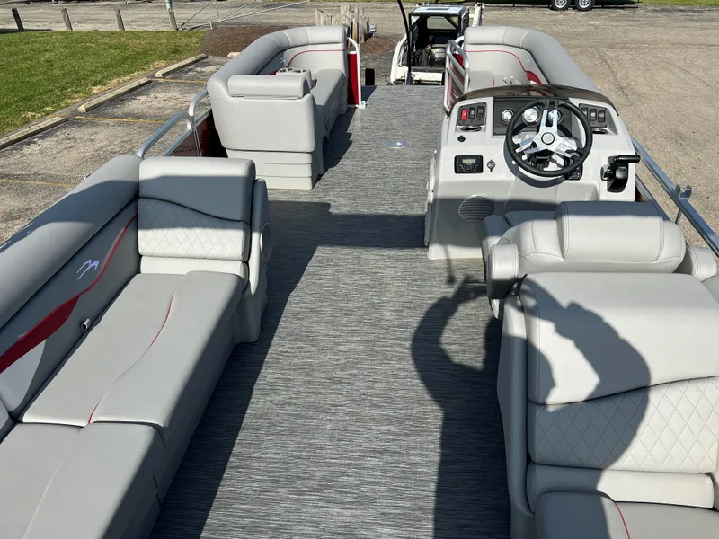 Slide: The Image of 2023 Bennington SV Line pontoon boat interior with gray seating and steering console. - 1