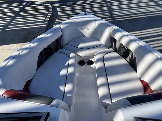 Slide: The Image of 2006 Moomba Outback boat interior with white cushioned seating and cup holders. - 12