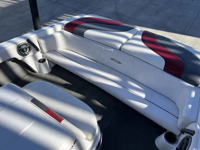 Slide: The Image of 2006 Moomba Outback boat interior with white, red, and gray seating. - 13