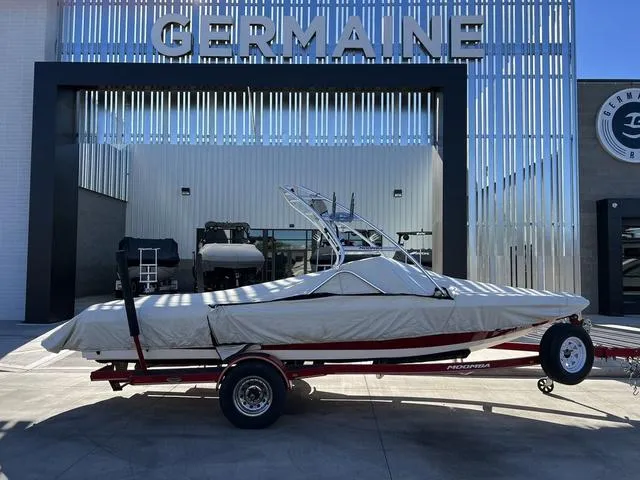 Slide: The Image of 2006 Moomba Outback boat on trailer, covered, parked at Germaine dealership. - 16