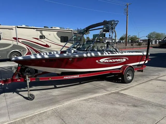 Slide: The Image of 2006 Moomba Outback red and white boat on trailer. - 5