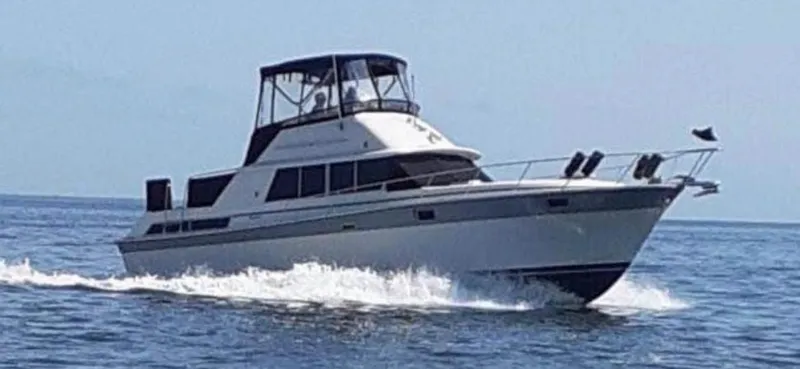 The Image of 1985 Silverton 40 Double Cabin cruising on open water. - 0