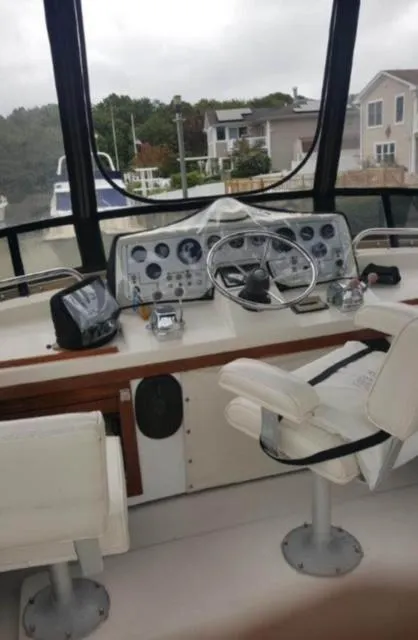 Slide: The Image of 1985 Silverton 40 Double Cabin boat helm with steering wheel and navigation instruments. - 2