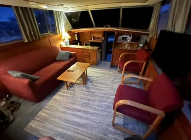 Slide: The Image of Interior of 1985 Silverton 40 Double Cabin with cozy seating and wooden furnishings. - 3