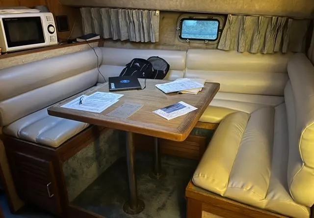 Slide: The Image of 1985 Silverton 40 Double Cabin interior with dining area and seating. - 4