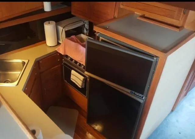 Slide: The Image of 1985 Silverton 40 Double Cabin kitchen with sink, stove, and refrigerator. - 5