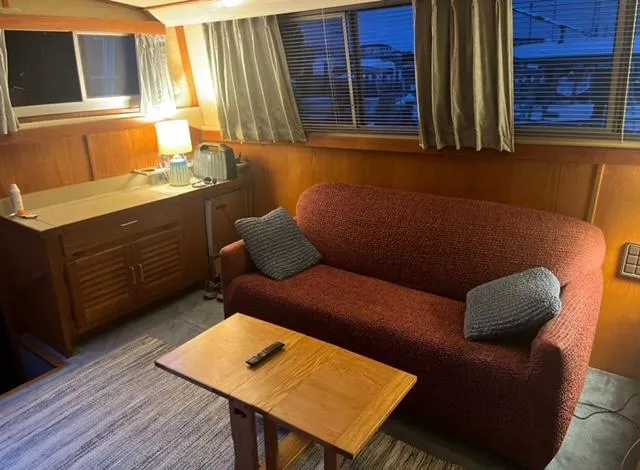 Slide: The Image of Cozy interior of 1985 Silverton 40 Double Cabin with sofa, table, and kitchenette. - 6