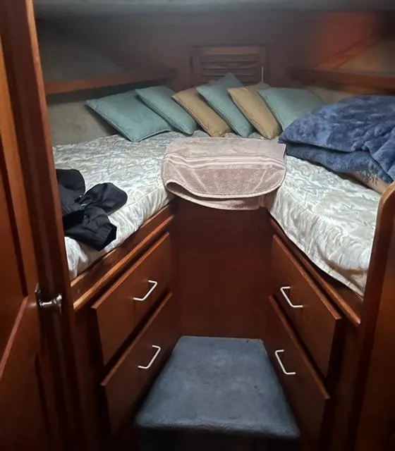 Slide: The Image of 1985 Silverton 40 Double Cabin interior with cozy bed and storage drawers. - 8