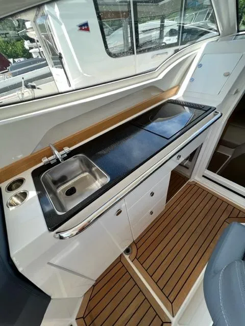 Slide: The Image of 2019 Nimbus W9 boat interior with kitchenette and sink. - 12