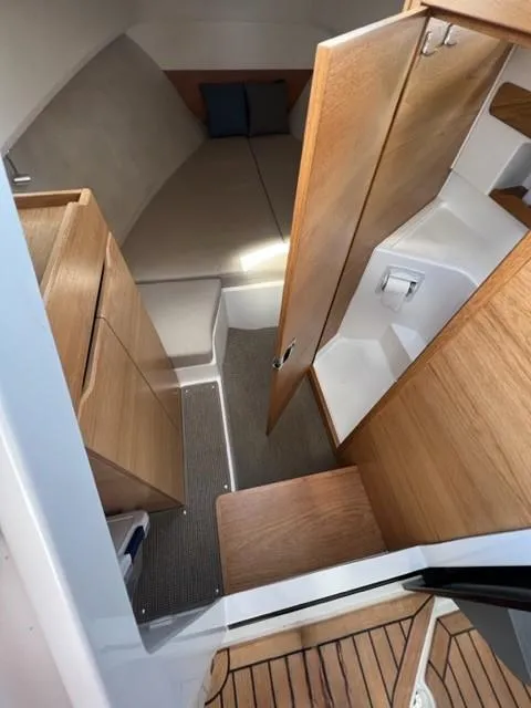 Slide: The Image of Interior cabin of 2019 Nimbus W9 boat with wooden finishes and cozy sleeping area. - 18
