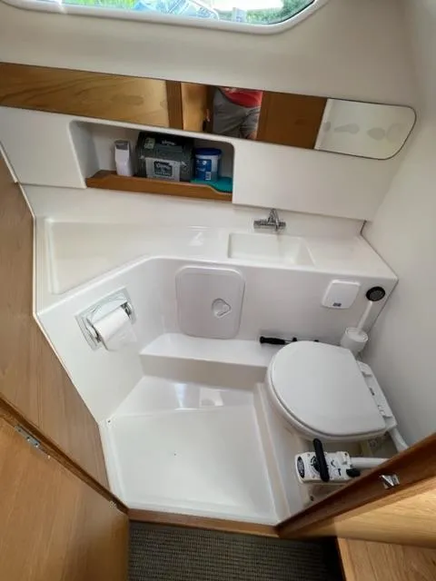 Slide: The Image of Compact bathroom in 2019 Nimbus W9 boat with toilet, sink, and storage shelves. - 19