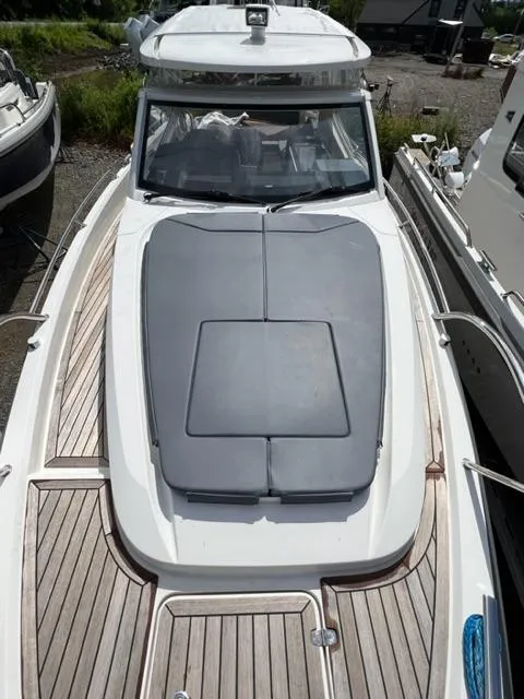 Slide: The Image of 2019 Nimbus W9 boat with wooden deck and cushioned bow area. - 5