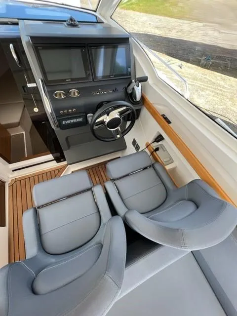 Slide: The Image of Interior cockpit of 2019 Nimbus W9 boat with dual seats and modern controls. - 7
