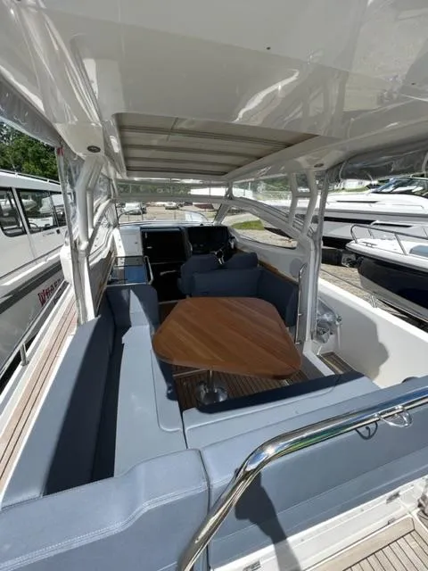 Slide: The Image of 2019 Nimbus W9 boat interior with seating and table. - 9