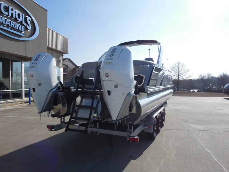 Slide: The Image of 2024 Bennington 27 QXFBWAT2 pontoon boat with dual outboard engines at Nichols Marine. - 3
