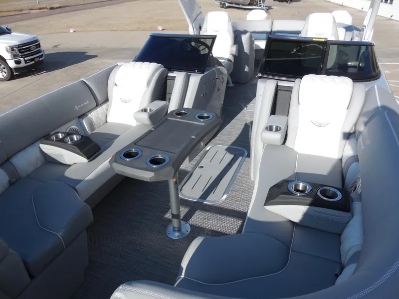 Slide: The Image of 2024 Bennington 27 QXFBWAT2 luxury pontoon boat interior with plush seating and cup holders. - 5